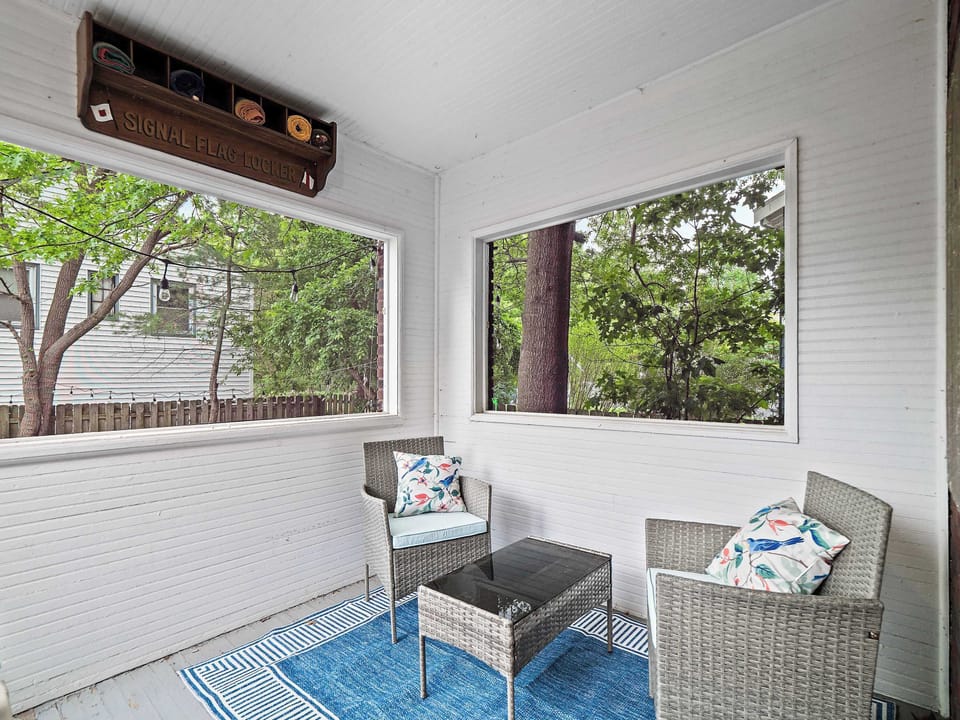 Sun-drenched sunroom w/ blue accent chair & large windows — a bright retreat to start the day.
