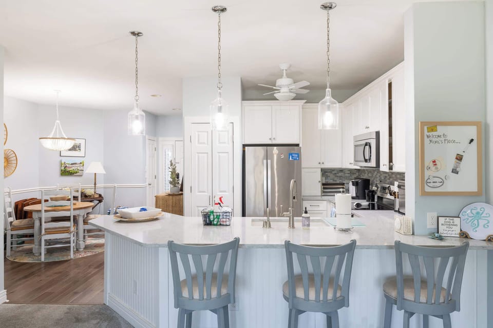 Spacious kitchen island with bar seating and an open layout that connects seamlessly to the dining and living areas