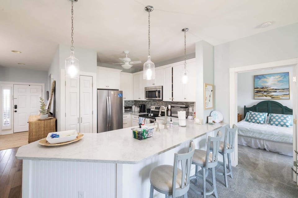 Spacious kitchen island with bar seating and an open layout that connects seamlessly to the dining and living areas
