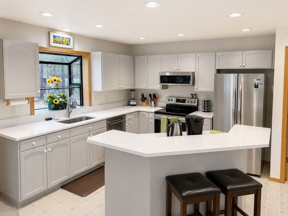 Large open kitchen is fully equipped for cooking-in with bar seating for two.