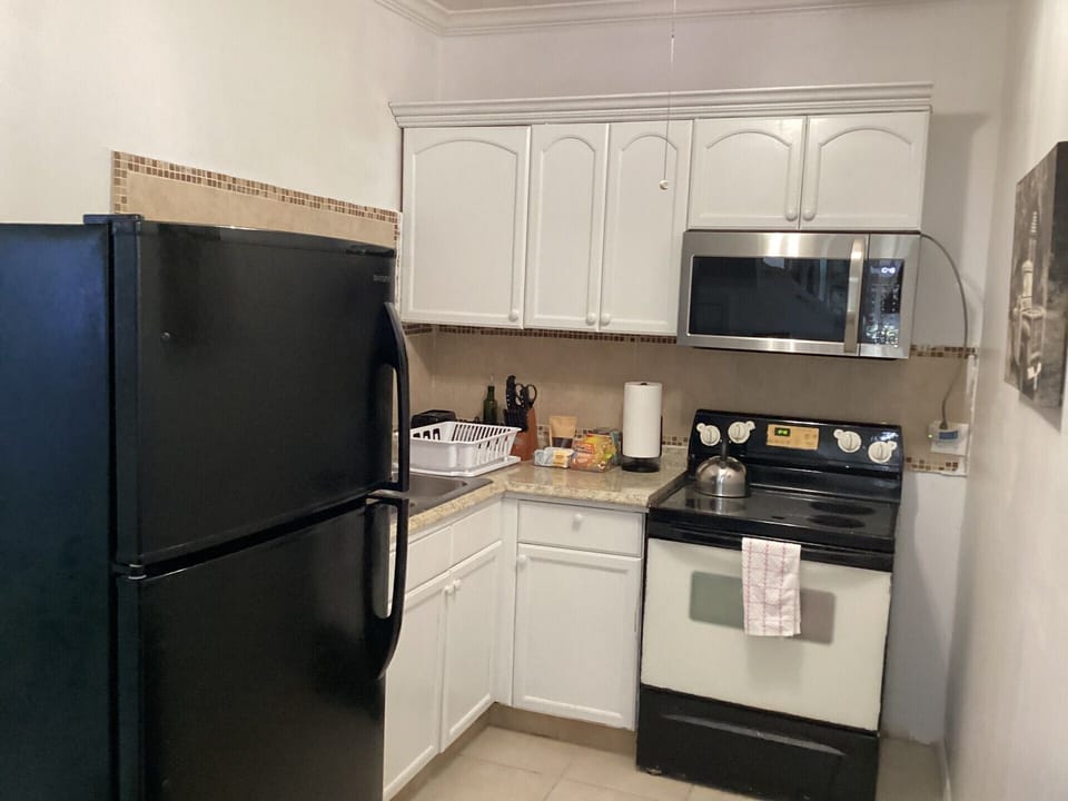 Condo, Balcony, Garden View | Private kitchen | Full-size fridge, microwave, oven, stovetop