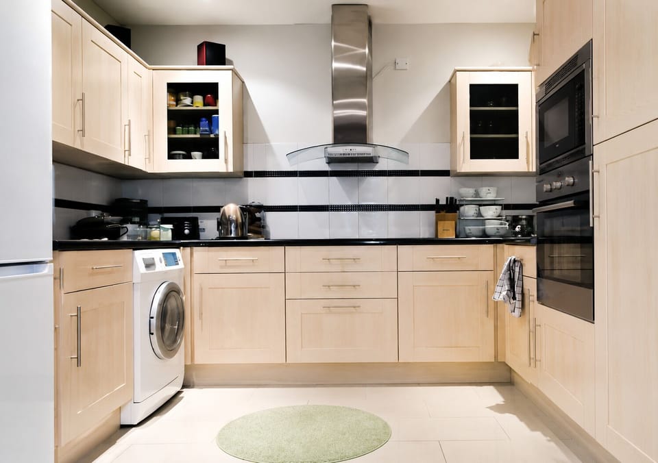 Modern spacious kitchen overlooking garden and dining area all mod coms