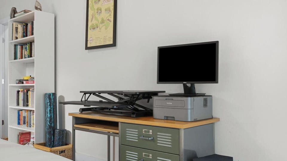 Need to log on while you’re in town? This thoughtful workspace offers a monitor, adjustable desk, and room to stay productive.