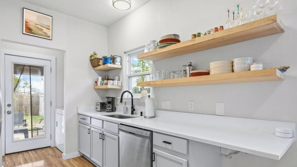 Brew your morning coffee or prep a group dinner in the fully stocked kitchen. Open shelving keeps everything within reach.