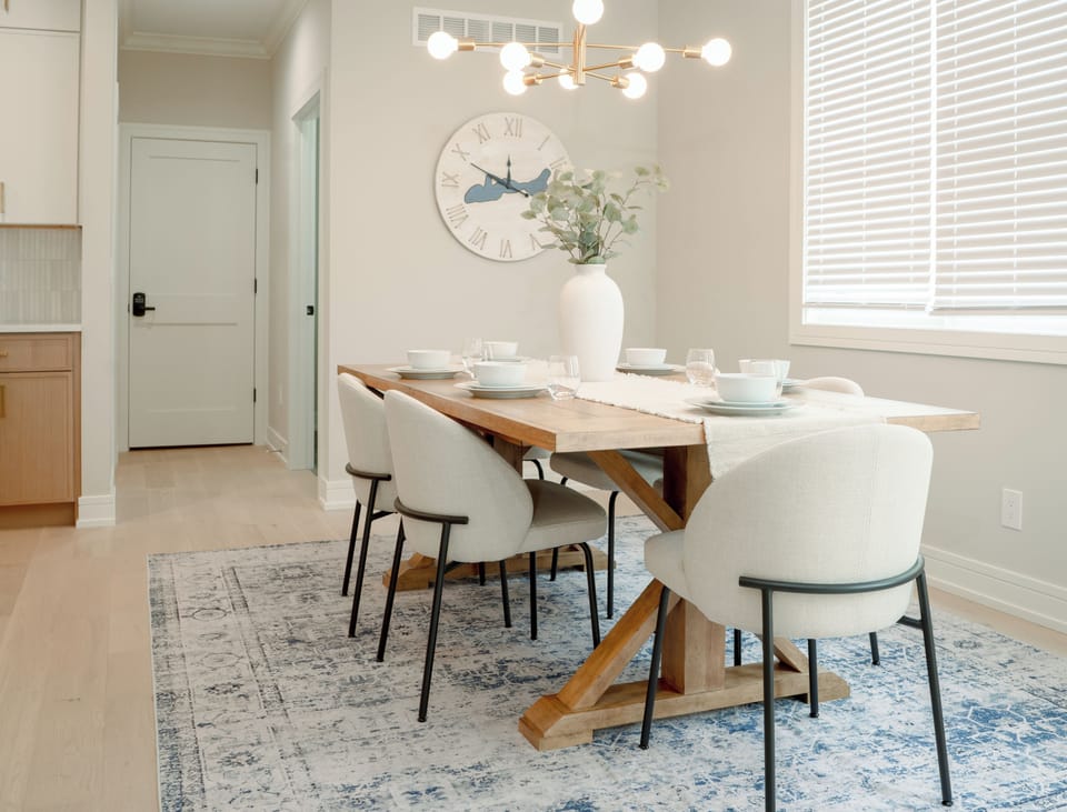 Dining table for 6 with additional seating at the oversized island.