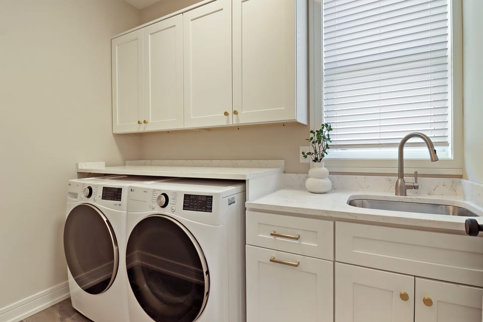 Full laundry with iron, and ironing board.