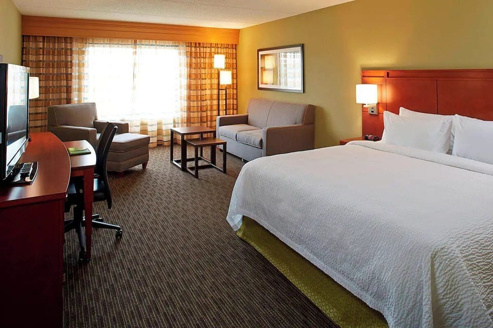 Unwind in a bright, spacious room with plush bedding.