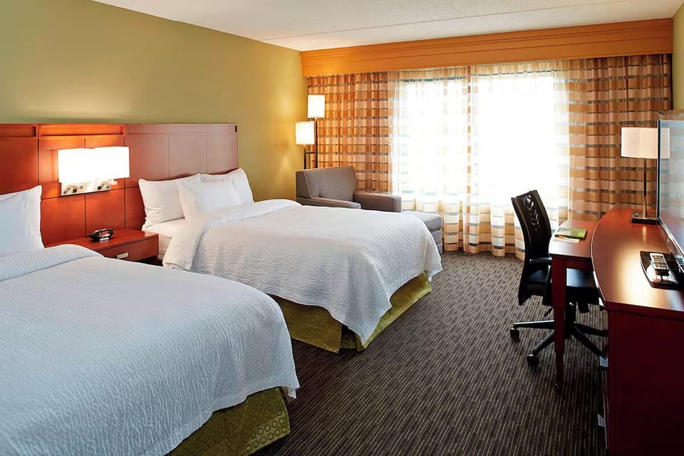 Recharge comfortably with two cozy beds and a work desk.
