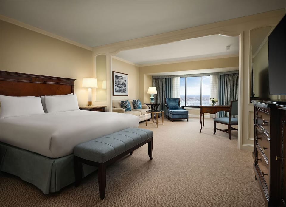 Relax in a plush king bed with calming city views.