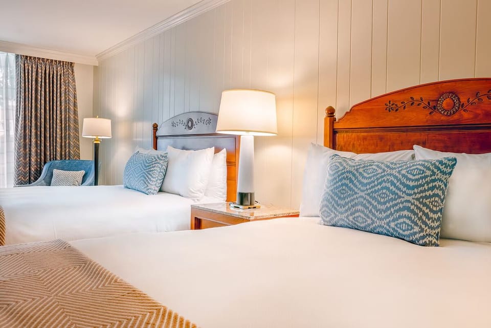 Unwind in crisp linens with warm bedside lighting.