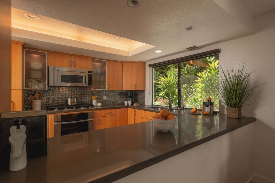 The kitchen opens to the adjacent media room.