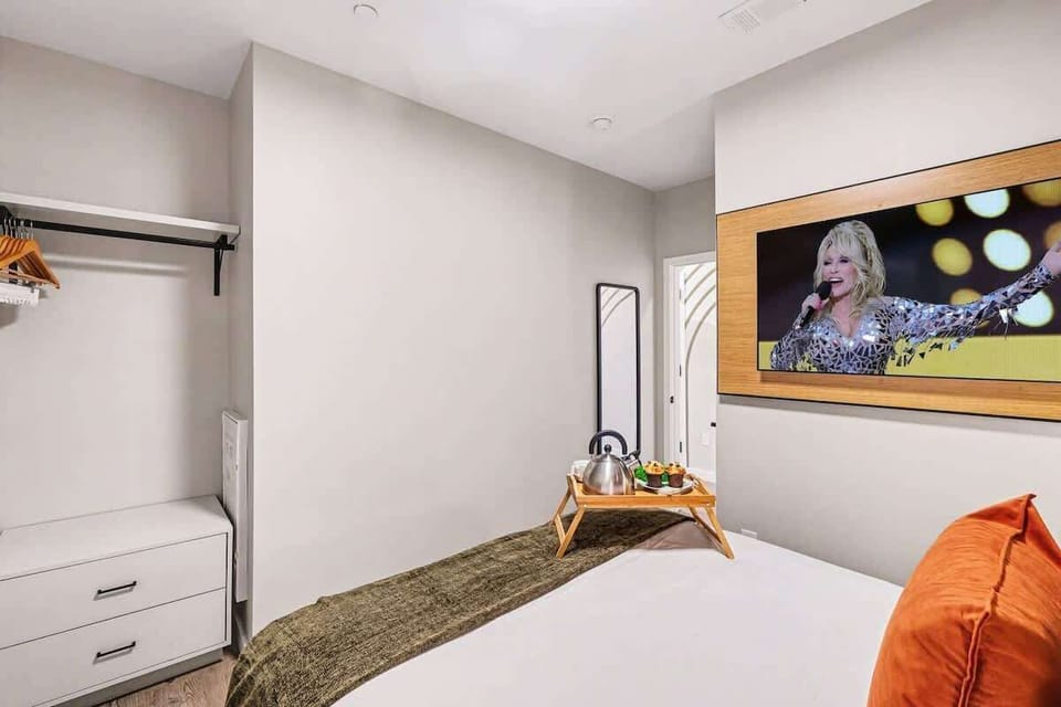 Primary Bedroom featuring a Queen bed, smart TV, and closet space.