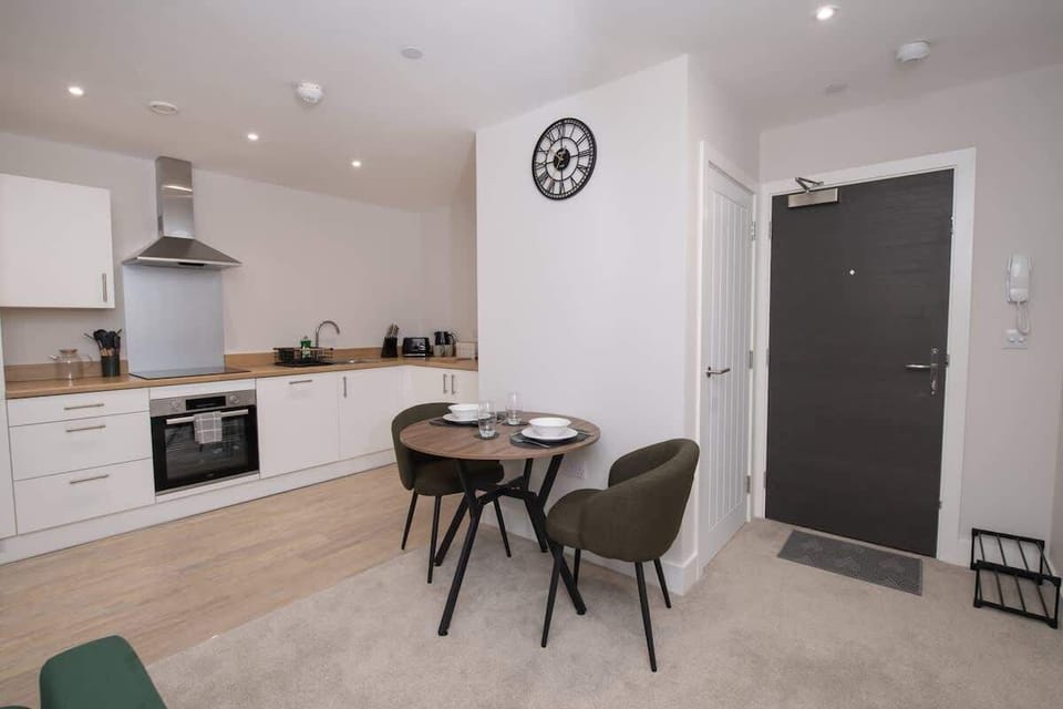 Unwind in our cozy living room featuring a smart TV for movie nights, with a spacious open-plan layout that flows seamlessly into the kitchen and dining area.