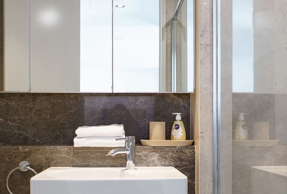 A modern and spacious bathroom with elegant finishes and a walk-in shower for a refreshing start to the day.