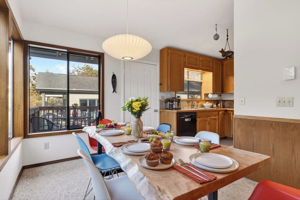 View from the dining table toward the wood-cabinetry kitchen.