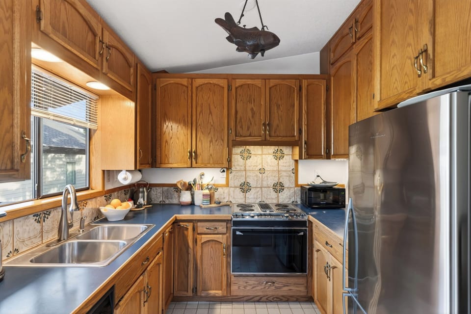 Wide view of the kitchen layout and sink area.