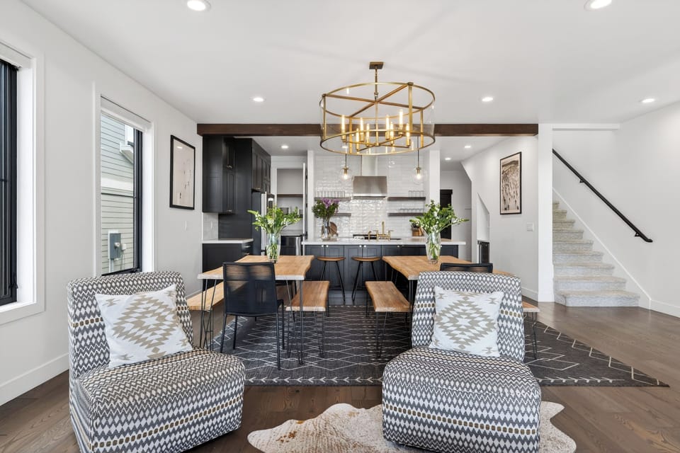 Cozy modern living room with a spacious sectional and sweeping mountain views through oversized windows.