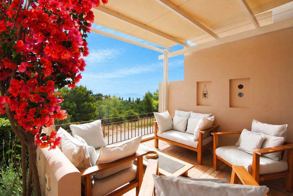 Covered Outdoor Lounge and Dining Space Surrounded by Bougainvillea (East Facing)