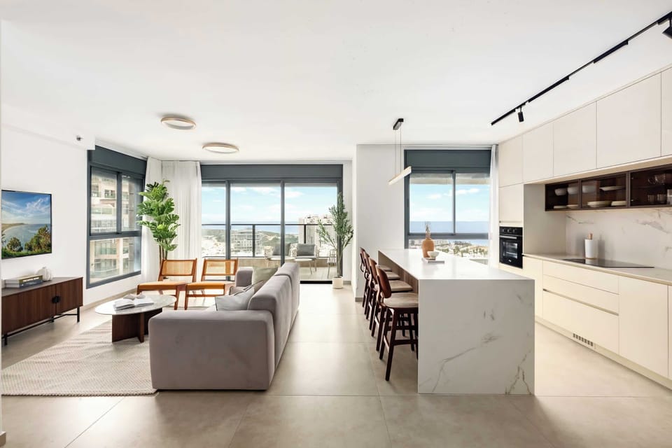 Open-plan hub uniting living area, chef-ready island, statement lighting, effortless socializing during shared meals together