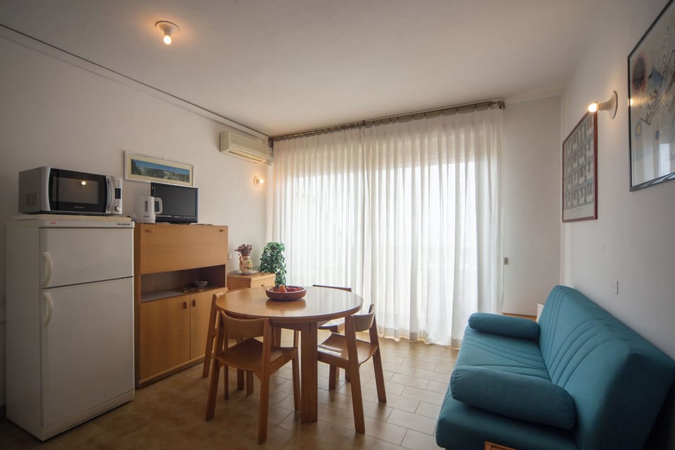 Apartment, Sea View | Living area | Flat-screen TV