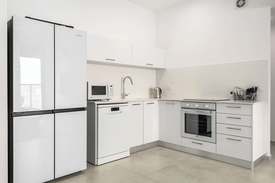 Contemporary kitchen corner offers generous storage, intuitive layout, and everything needed for comfortable extended stays.
