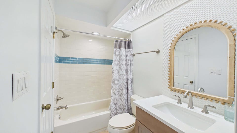 Guest bathroom with newly finished vanity and shower/tub combo