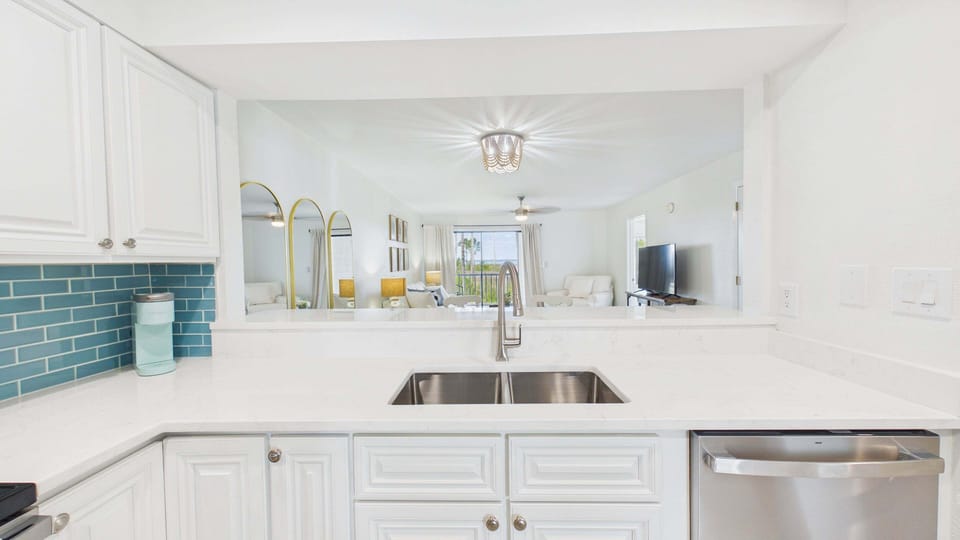 Deep basin kitchen sink perfect for your culinary needs + bay views from over the kitchen counter!
