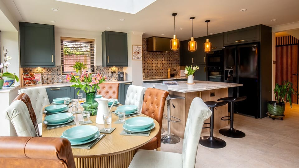 The heart of the home is the expansive open-plan kitchen and dining area.