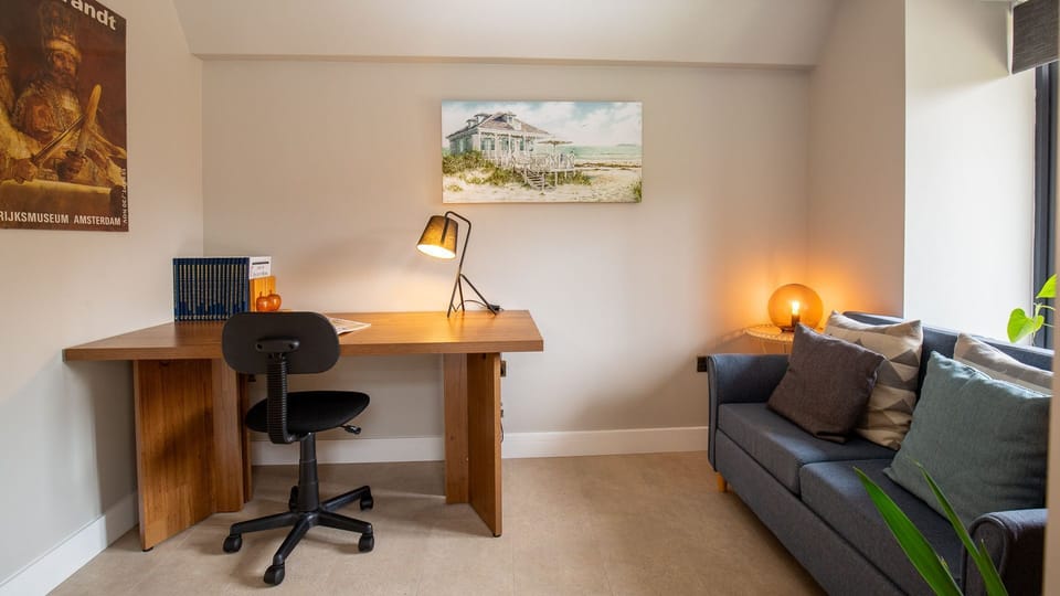 A sophisticated space featuring a desk for remote work.