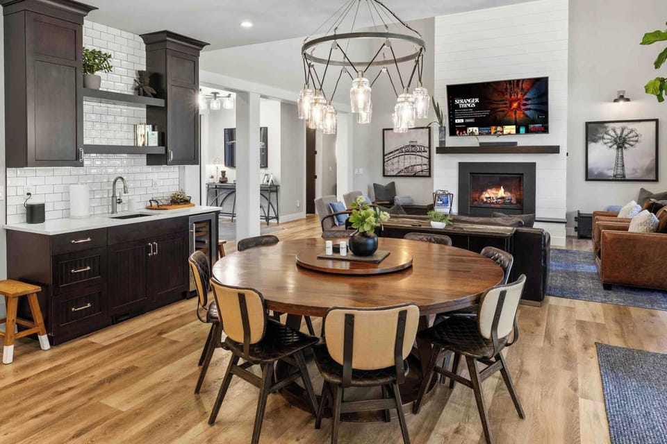 The round table seats the whole group, with the fireplace and big-screen TV just steps away