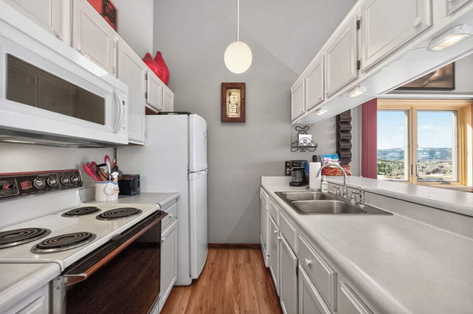 Your fully equipped galley kitchen features everything you need, from coffee maker to full appliances, with stunning city views.