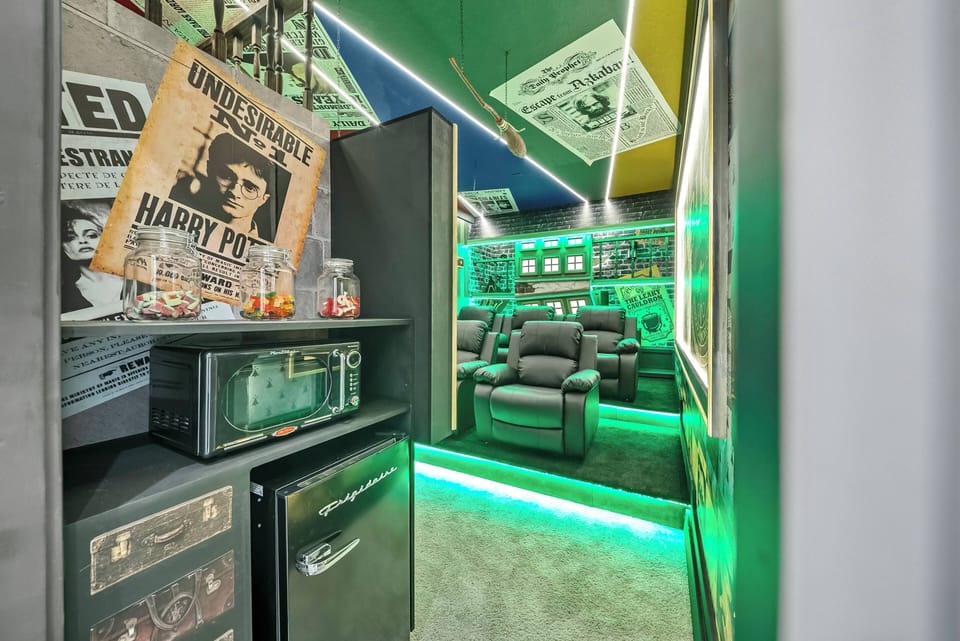 Experience a lively entertainment space with cozy reclining chairs set for movie nights. Bright green ambient lighting adds a playful vibe, and vintage posters create a whimsical atmosphere perfect for relaxation and enjoyment.
