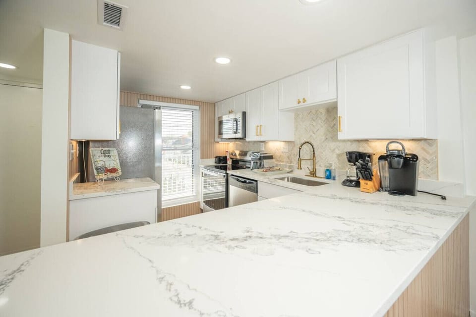 Fully updated kitchen with quartz countertops, stainless steel appliances, and everything you need for group meals.