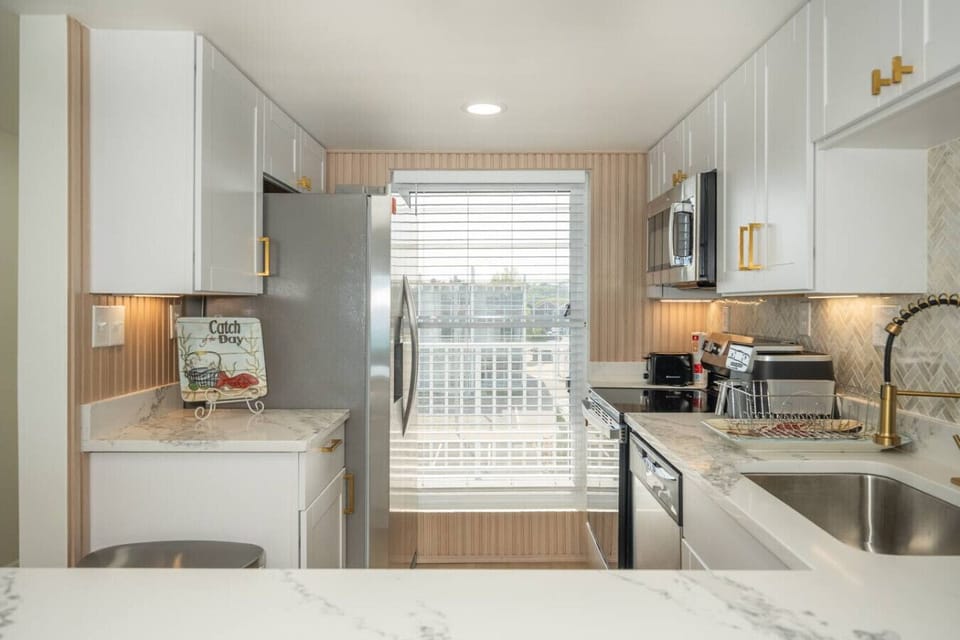 Modern coastal kitchen fully stocked for easy meals and morning coffee before the beach