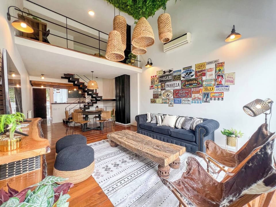 Bright open living + dining area with a table seating 6 and kitchen counter for 3—perfect for meals, gatherings, or simply soaking in the Buenos Aires vibes.