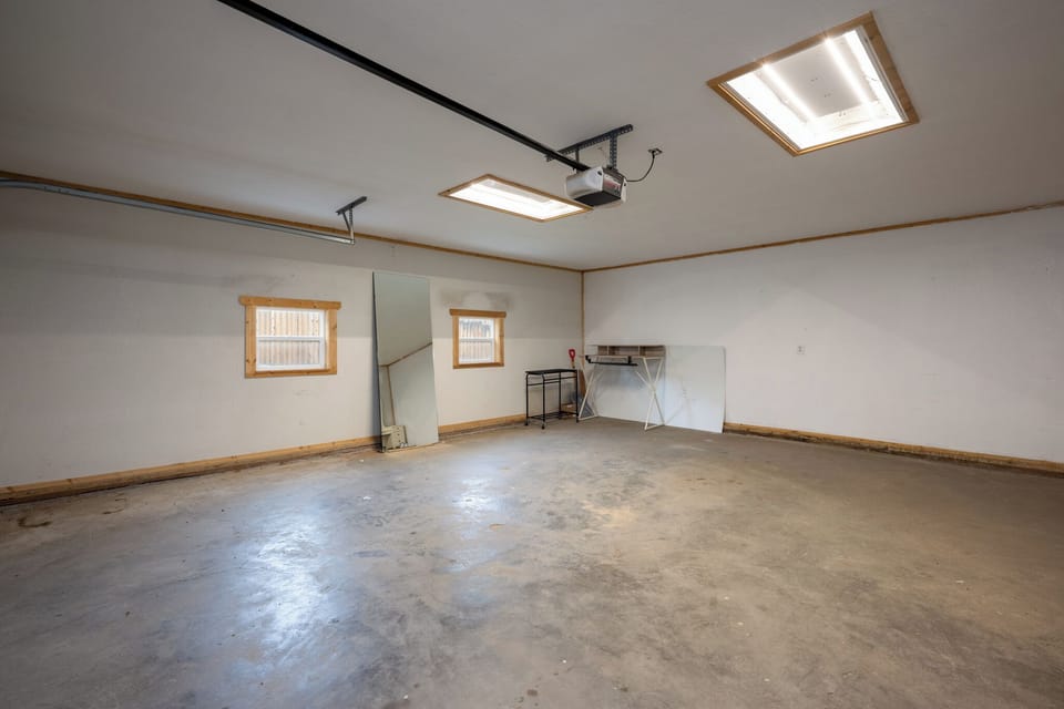 This property features a spacious interior with natural light streaming through ceiling skylights and wood-trimmed windows, plus convenient storage space to keep your belongings organized.