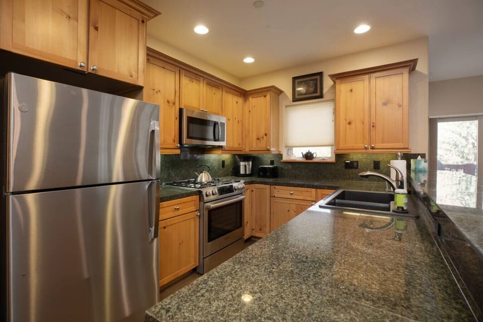 Open concept kitchen with bar seating, dining table and fully stocked with everything you need!