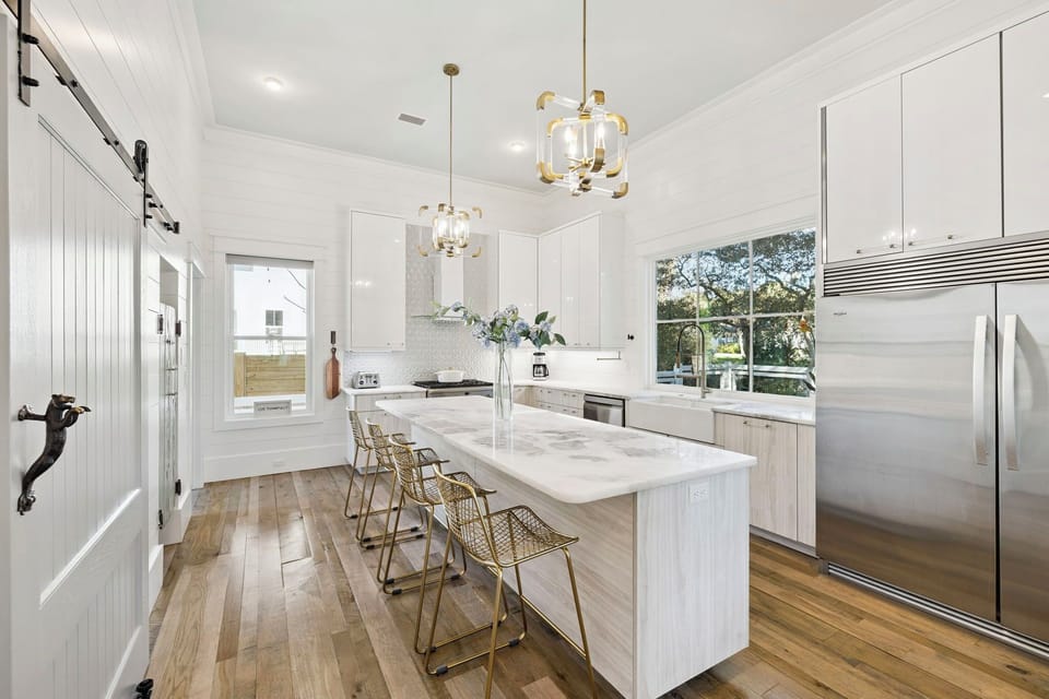 Your dream kitchen awaits with gleaming marble counters, designer pendant lights, and top-tier stainless appliances perfect for creating memorable meals.