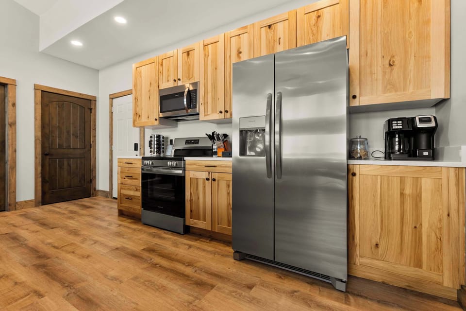 Fully equipped kitchen on the upper level with modern appliances, ample counter space, and everything you need to prepare gourmet meals during your stay.