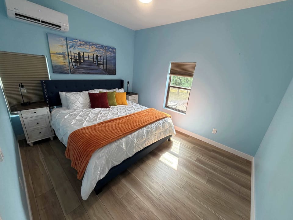 King Suite featuring a plush king bed and a convenient nightstand for your essentials.