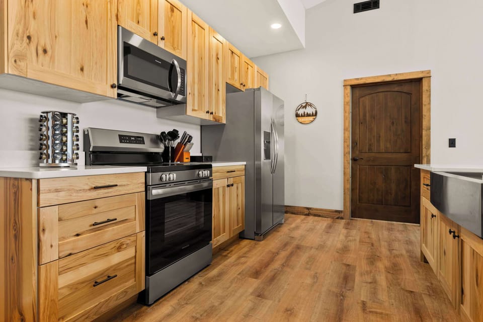 Open-concept fully equipped kitchen on the upper level with modern appliances and lake views.