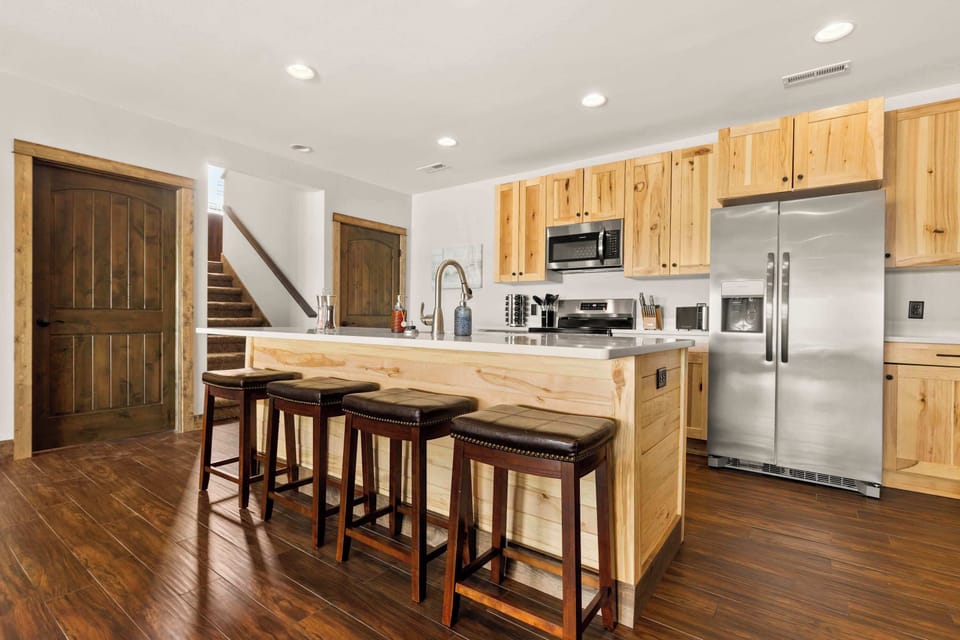 Second kitchen on the lower level, fully equipped with modern appliances and ample counter space for preparing large family meals.