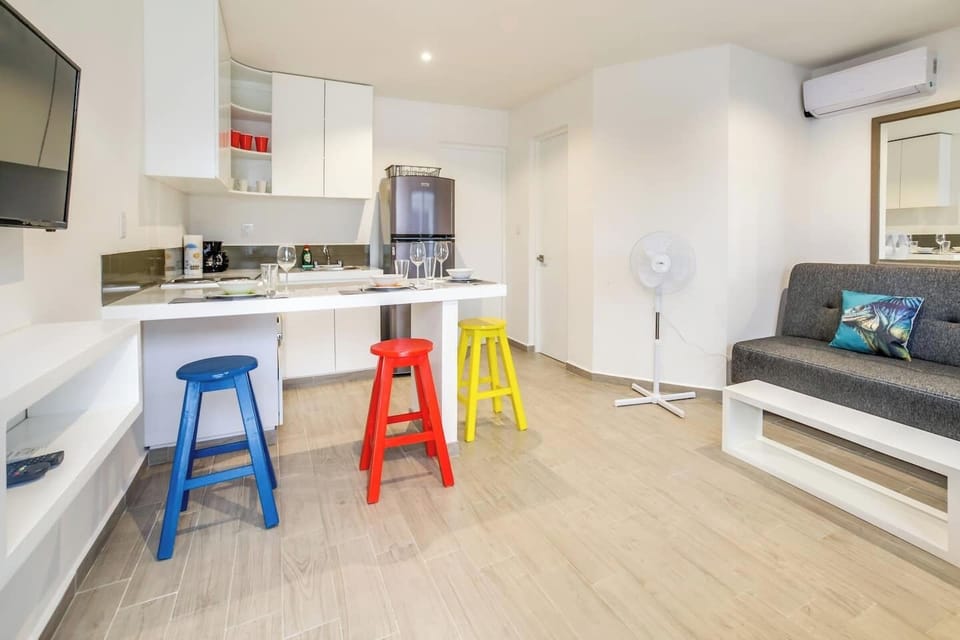Living room, kitchen and dining. Sofa folds flat for an extra sleeping space 