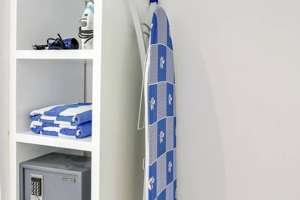Closet in bedroom with Beach towels, security box, hair dryer and iron