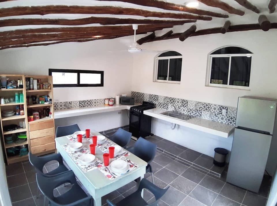 Kitchen with full stove and oven, refrigerator, coffee maker and blender