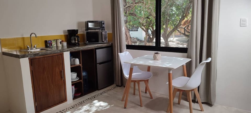Refrigerator with freezer, coffee/tea, toaster oven, microwave, dishes.