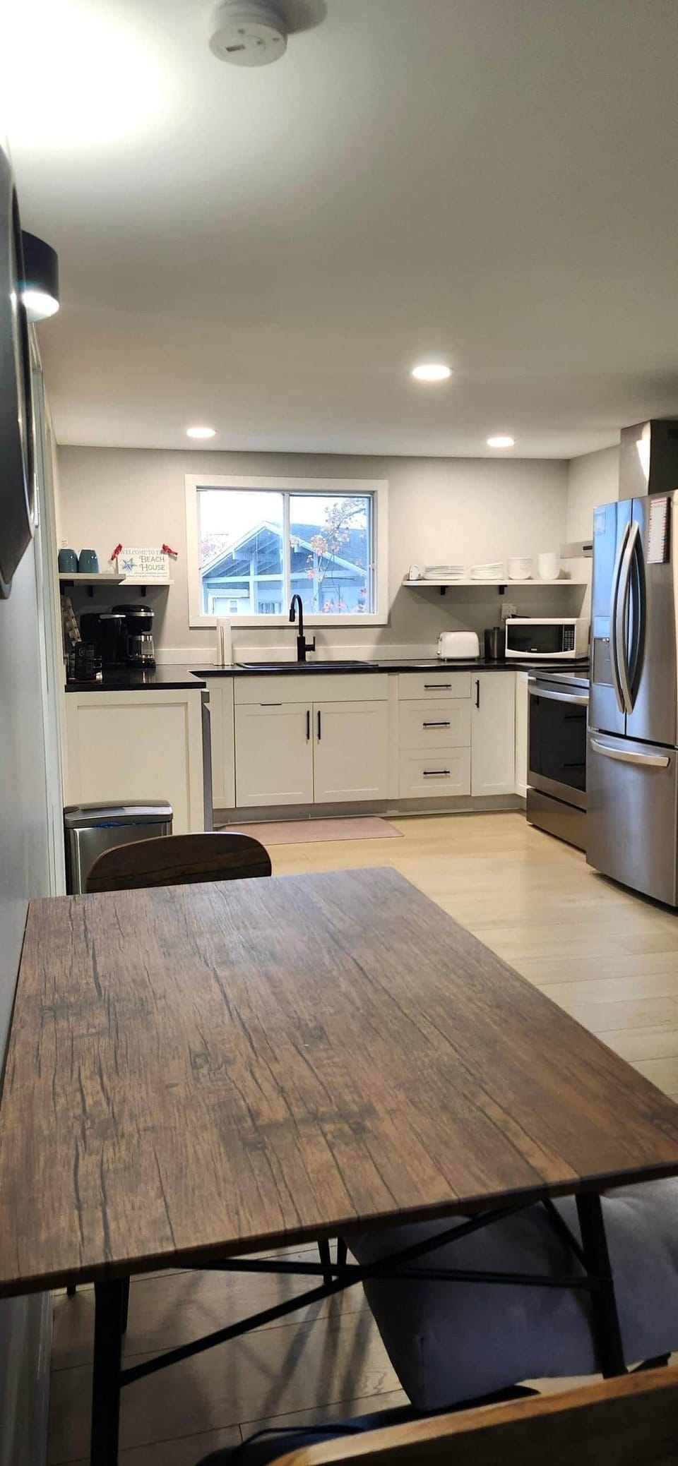 Kitchen: Dishwasher, Fridge, Stove, Microwave,  Toaster, Coffee Maker, Dining Table and Chairs.