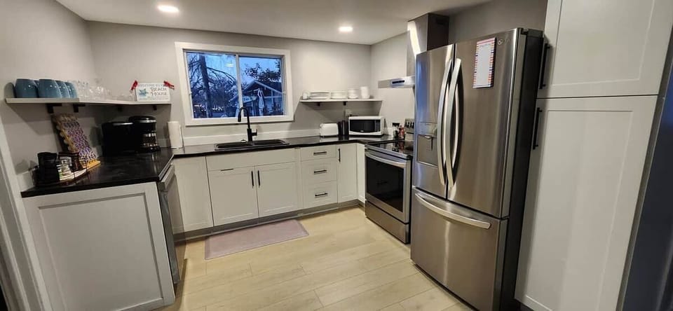 Kitchen: Dishwasher, Fridge, Stove, Microwave,  Toaster, Coffee Maker, Dining Table and Chairs.