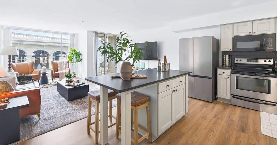 A spacious and modern living area with a fully equipped kitchen island and a comfortable lounge space.