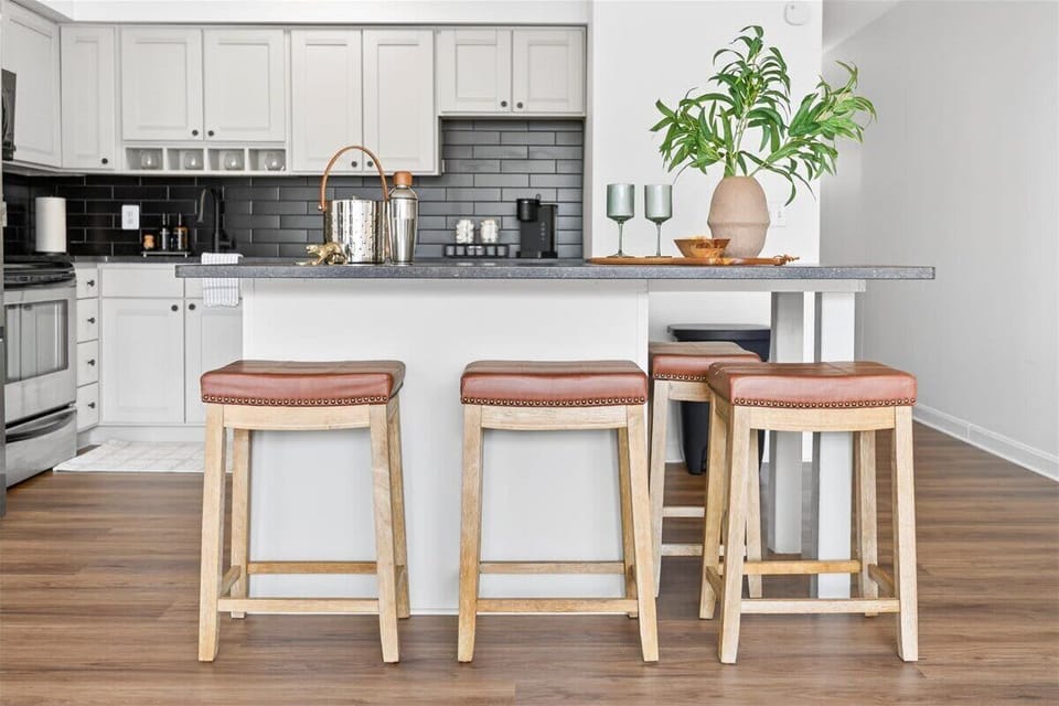 A cozy kitchen space centered on a table with three chairs for simple, comfortable dining.